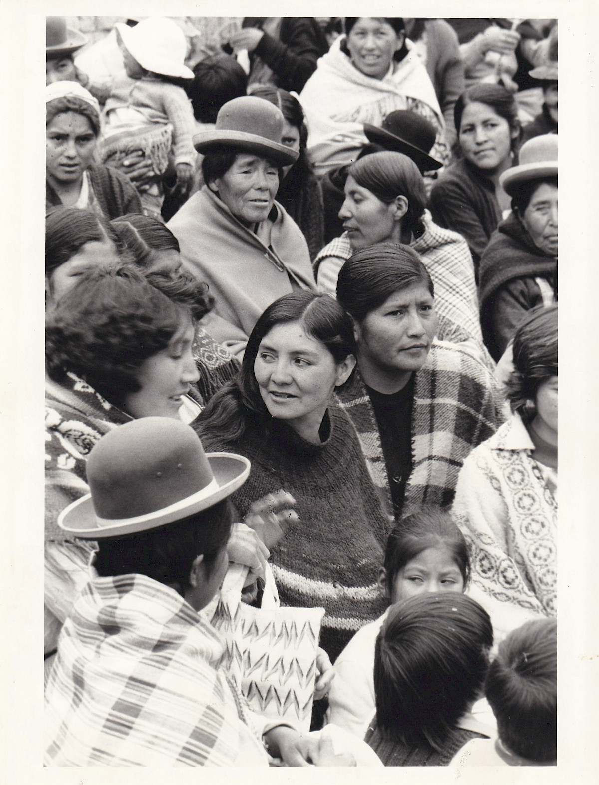 Photograph for ‘Seeds of Resistance’ (1985) by Juliet Miller. The back of the photograph reads: 'La Paz, Bolivia. November 1984. Dominga Valesquez, President of the Amas de Casa (Women's Federation), centre of the picture, surrounded by other members. Photographer: Danielle Caillet.'